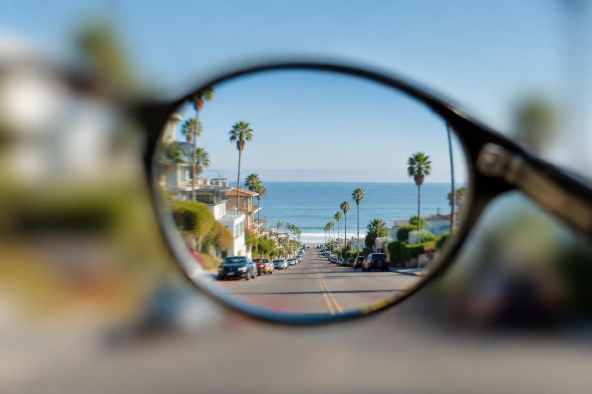 Coastal California street seen sharply through a lens against a blurred background